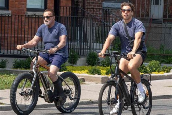 Joseph Baena, 23, Bonds With Dad Arnold Schwarzenegger On Venice Beach Bike Ride — See Pics